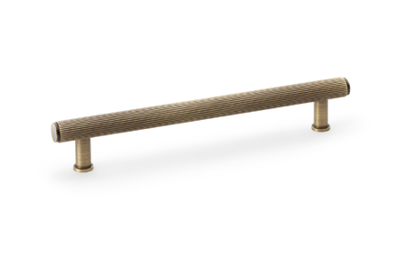 View Alexander & Wilks Crispin Reeded T-bar Cupboard Pull Handle - Antique Brass - 160mm offered by HiF Kitchens