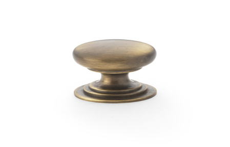 View Alexander & Wilks Waltz Round Cupboard Knob on Stepped Rose - Antique Brass - 25mm offered by HiF Kitchens